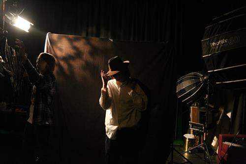 Noir lighting setup with subject in a hat